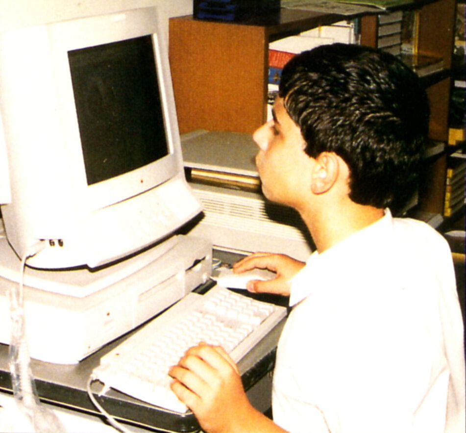 A young Mihai in front of a Centris 660/AV with an AppleVision 1710AV display